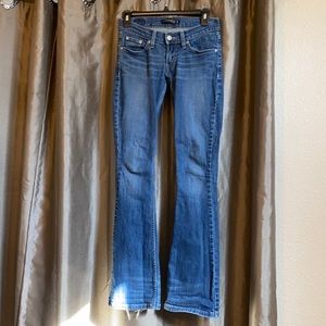 A pair of Levi 524 jeans, faded blue. Used